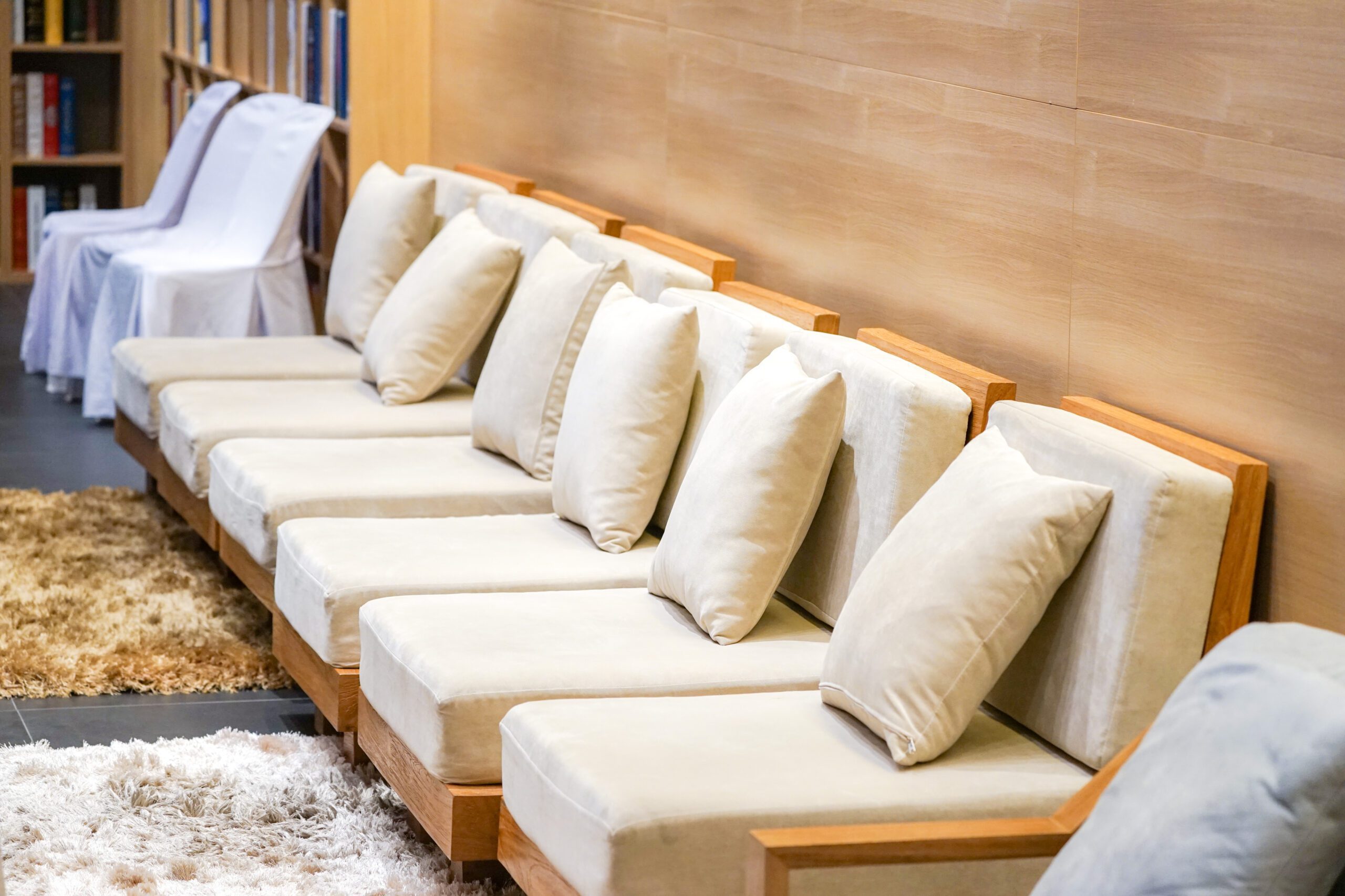 classic creamy and wooden sofa in Bangkok Tourist Lounge for welcome VIP person with luxury capet.