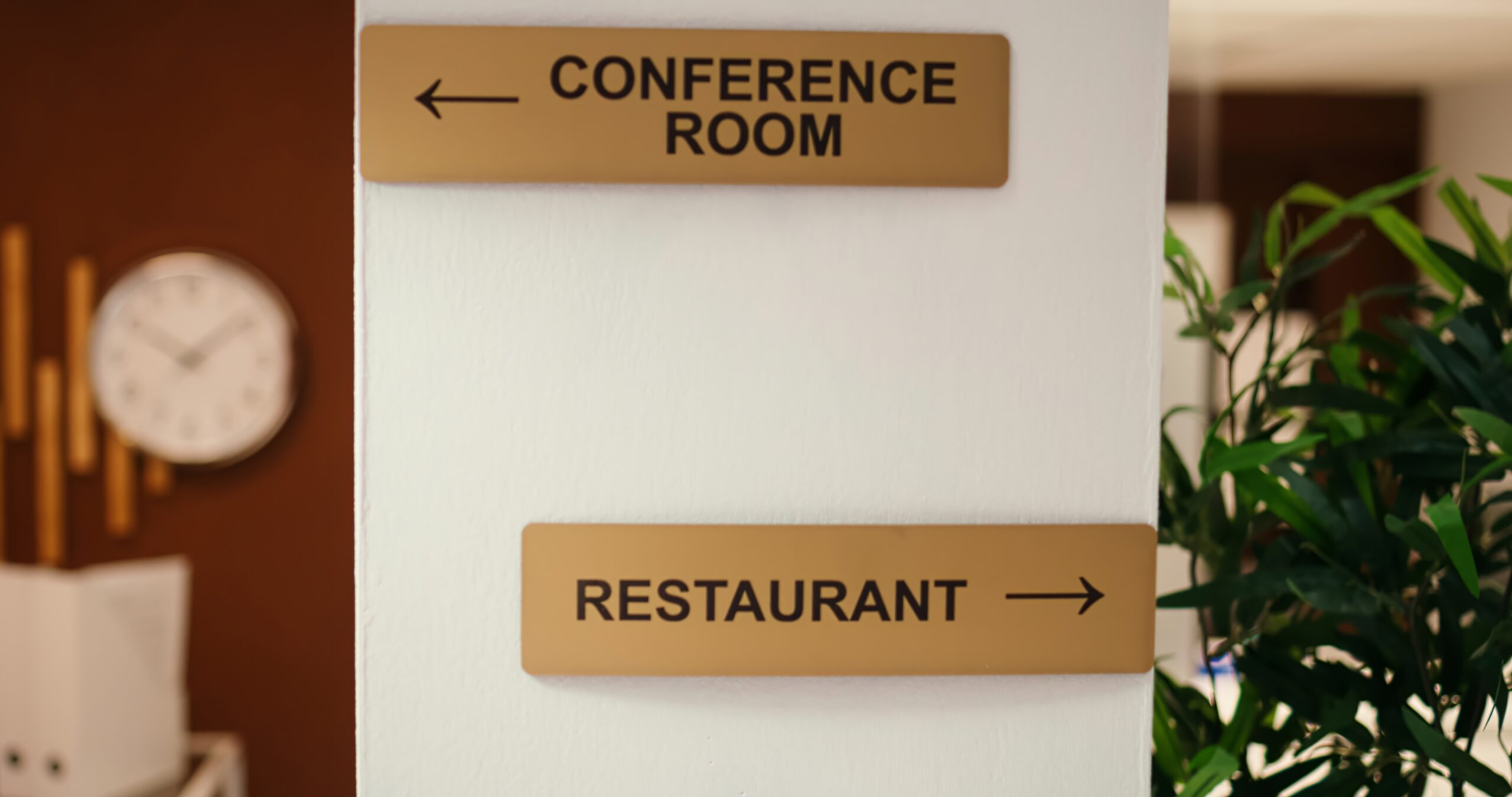 Close up jib shot of conference room, spa center and restaurant amenities signs in empty business hotel lounge interior. Cozy luxurious stylish resort lobby waiting for arriving tourists